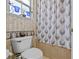 Bathroom with stylish shower curtain and toilet with blue accents at 7957 S Park Pl, Orlando, FL 32819
