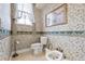 Lovely bathroom with patterned wallpaper and window with curtain at 7957 S Park Pl, Orlando, FL 32819