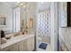 Bathroom with nice vanity, mirror and shower with blue accents at 7957 S Park Pl, Orlando, FL 32819
