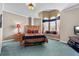 Inviting bedroom with a sitting nook in the bay window, wooden furnishings, and soft lighting at 7957 S Park Pl, Orlando, FL 32819