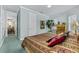 Serene bedroom featuring soft blue walls, large windows, and access to the second floor landing at 7957 S Park Pl, Orlando, FL 32819