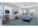 Cozy bedroom with three windows and a mounted TV at 7957 S Park Pl, Orlando, FL 32819