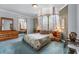 Cozy bedroom with bay windows, soft lighting, and mirrored closet doors at 7957 S Park Pl, Orlando, FL 32819