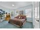 Comfortable bedroom with bright blue walls, large windows, and stylish decor at 7957 S Park Pl, Orlando, FL 32819