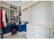 Walk in closet with white shelving and rods at 7957 S Park Pl, Orlando, FL 32819