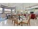 Open dining area with a glass table, natural light, and a partial kitchen view at 7957 S Park Pl, Orlando, FL 32819