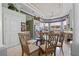 Dining area with glass table and views into the kitchen and natural lighting at 7957 S Park Pl, Orlando, FL 32819