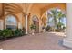 Elegant entrance of the home with stone columns, manicured landscaping and a rich wood door at 7957 S Park Pl, Orlando, FL 32819