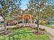 Stunning two-story home with a beautiful lawn, brick driveway and exquisite water fountain at 7957 S Park Pl, Orlando, FL 32819