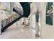Bright foyer with a spiral staircase, marble flooring, and decorative plant at 7957 S Park Pl, Orlando, FL 32819