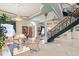 Spacious foyer featuring marble floors, elegant staircase, and sophisticated decor create a grand entrance at 7957 S Park Pl, Orlando, FL 32819