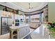 Gourmet kitchen features an island with wine storage, stainless appliances, and decorative wallpaper at 7957 S Park Pl, Orlando, FL 32819
