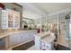 Open-concept kitchen with white cabinetry, granite countertops, and adjacent breakfast area at 7957 S Park Pl, Orlando, FL 32819