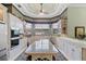 Spacious kitchen with an island, white cabinets, and decorative wallpaper at 7957 S Park Pl, Orlando, FL 32819