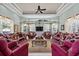 Spacious living room with large windows, elegant decor, and comfortable seating at 7957 S Park Pl, Orlando, FL 32819