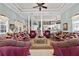 Living room with bright lighting, tray ceiling, and a view into the kitchen area at 7957 S Park Pl, Orlando, FL 32819