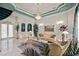 An elegant formal living room featuring high ceilings, marble floors, and a grand chandelier at 7957 S Park Pl, Orlando, FL 32819