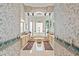 Elegant main bathroom featuring dual sinks, patterned wallpaper, marble tile floor, and soaking tub with columns at 7957 S Park Pl, Orlando, FL 32819