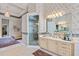 Elegant main bathroom featuring large vanity with dual sinks and a luxurious glass enclosed shower at 7957 S Park Pl, Orlando, FL 32819
