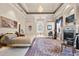 Spacious main bedroom features tray ceilings, a chandelier, and ensuite bathroom at 7957 S Park Pl, Orlando, FL 32819