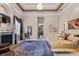 Primary bedroom with a fireplace, carpet, and a view into an ensuite bathroom at 7957 S Park Pl, Orlando, FL 32819