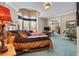 Comfortable main bedroom with large windows, TV, and carpeted floor at 7957 S Park Pl, Orlando, FL 32819