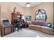 Home office featuring a sofa, desk, and large window at 7957 S Park Pl, Orlando, FL 32819