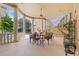 Covered outdoor dining space with Roman mural, fan, pillars and railing at 7957 S Park Pl, Orlando, FL 32819