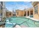 A screened-in pool with a jacuzzi and summer kitchen add luxury to this property at 7957 S Park Pl, Orlando, FL 32819