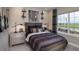 A stylish bedroom showcasing a comfortable bed, unique decor, and a window with a scenic view at 861 Junonia Blvd, New Smyrna Beach, FL 32168