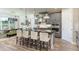 A view of the kitchen island with barstool seating and a dining area bathed in natural light from the nearby window at 861 Junonia Blvd, New Smyrna Beach, FL 32168