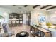 Open-concept living room showcasing kitchen and dining area with hardwood floors and modern decor at 861 Junonia Blvd, New Smyrna Beach, FL 32168