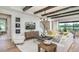 Bright living room featuring stylish furnishings, including a comfortable sofa, modern decor, and a view of the outdoors at 861 Junonia Blvd, New Smyrna Beach, FL 32168