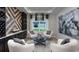 A cozy sitting area with modern decor, comfortable chairs, and a stylish light fixture at 861 Junonia Blvd, New Smyrna Beach, FL 32168