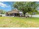 Spacious backyard with screened lanai, lush lawn, and mature trees, perfect for outdoor living at 905 N Lake Claire Cir, Oviedo, FL 32765