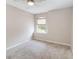 Neutral bedroom with neutral walls, ceiling fan, carpet flooring, and window at 905 N Lake Claire Cir, Oviedo, FL 32765