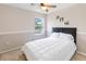 Comfortable bedroom featuring a ceiling fan and natural light from the window at 905 N Lake Claire Cir, Oviedo, FL 32765