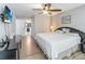 Spacious bedroom with wood floors, ceiling fan and an ensuite bathroom entrance at 905 N Lake Claire Cir, Oviedo, FL 32765