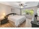 Relaxing bedroom featuring a ceiling fan and a large window offering natural light at 905 N Lake Claire Cir, Oviedo, FL 32765