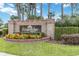 Kingsbridge West community sign surrounded by manicured landscaping and colorful flowers at 905 N Lake Claire Cir, Oviedo, FL 32765
