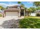 Two-story home featuring a brick driveway, two-car garage, manicured lawn, and a charming, welcoming front entrance at 905 N Lake Claire Cir, Oviedo, FL 32765