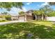 Charming two-story home featuring a large front yard, a two-car garage, and a well-maintained lawn with green grass at 905 N Lake Claire Cir, Oviedo, FL 32765