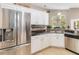 Modern kitchen with stainless steel refrigerator, white cabinets, and stylish backsplash at 905 N Lake Claire Cir, Oviedo, FL 32765