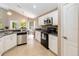 Bright kitchen with stainless steel appliances, white cabinets, and modern backsplash at 905 N Lake Claire Cir, Oviedo, FL 32765