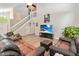 Open living room showing wood floors, lots of space, a staircase and large windows at 905 N Lake Claire Cir, Oviedo, FL 32765