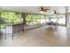 Spacious screened patio with ceiling fans, tile flooring and an outdoor kitchen area at 905 N Lake Claire Cir, Oviedo, FL 32765