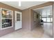 Enclosed patio featuring tile flooring, neutral color scheme, and an adjacent screened-in porch at 905 N Lake Claire Cir, Oviedo, FL 32765