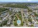 Overhead shot displays a vibrant neighborhood near a pool and park, highlighted by lush trees and well-kept homes at 908 Tilden Oaks Trl, Winter Garden, FL 34787