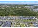 A scenic aerial shot reveals an organized neighborhood with a backdrop of lush greenery and a tranquil body of water nearby at 908 Tilden Oaks Trl, Winter Garden, FL 34787