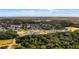 Aerial view of a suburban neighborhood surrounded by trees and a lake at 908 Tilden Oaks Trl, Winter Garden, FL 34787